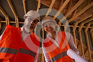 Foreman and construction supervisor posing for camera during house inspection