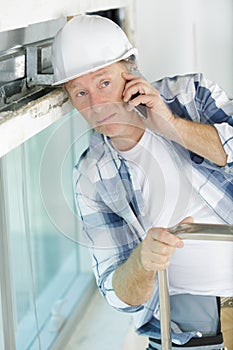 contractor on phone inside construction site