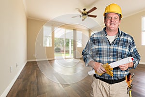 Contractor With Plans in Hard Hat In Empty Room with New Woodwood Floors