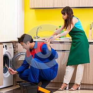 Contractor repairing washing machine at home