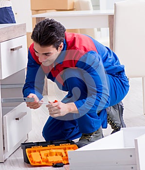 Contractor repairman assembling furniture under woman supervisio