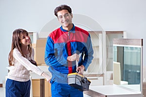 The contractor repairman assembling furniture under woman supervision