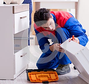 Contractor repairman assembling furniture under woman supervisio