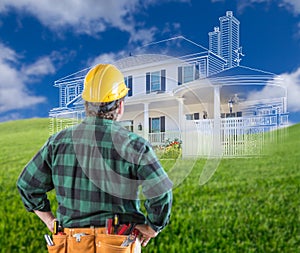 Contractor Standing Outdoors Looking Over Grass Site with Ghosted House.