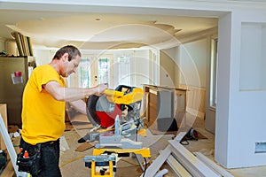 Contractor Using Circular Saw Cutting Crown Moulding for Renovation.