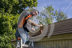 Contractor Using Clipboard To Figure Hail Damage Repair Costs