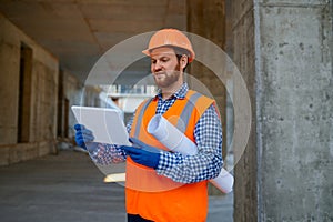 Contractor using digital tablet at construction site