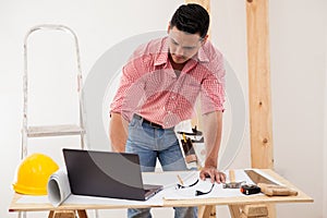 Contractor using a laptop at work