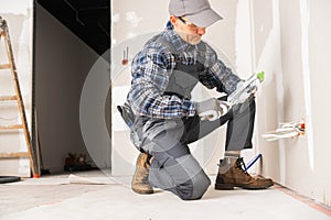 Contractor Worker in His 40s Patching Drywall