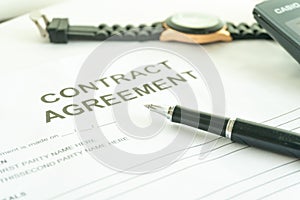 Contracts agreement sign on document paper with black pen.