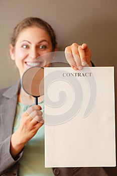 Business woman with contract and loupe