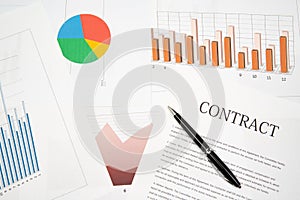 Contracts, charts, and graphs on the desk. Business desk concept photo