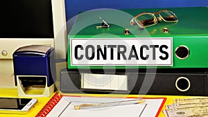 Contracts. Text label in the office folder. The prospect of planning financial profit