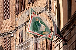 Contrade flag of the Oca-Goose city district hanging in a street in downtown Siena