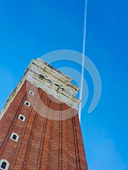 A contrail over passes over St Marks Campanile, Venice