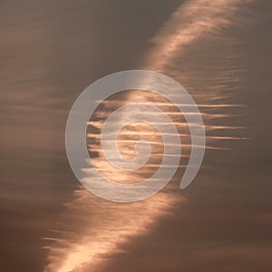 Contrail expands and twists clouds during FingerLakes NYS sunset photo