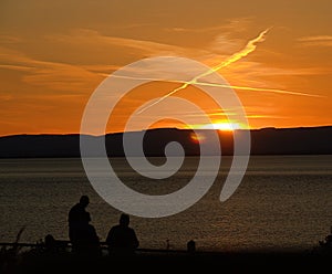 Contrails on sky at sunset