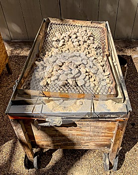 Contraption for roasting Goat. Embers are present in the top shelve with the goat inside the box