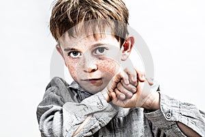 Contrast effect portrait, beautiful determined child with freckles looking bullied