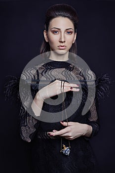 Contrast fashion woman portrait with big blue eyes on a dark bac