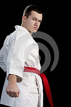 Contrast karate young fighter on black