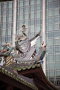 Contrast between modern glass facade and Chinese temple