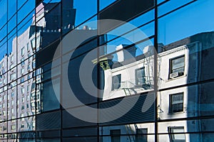 Contrast of modern and old buildings reflected in large modern glass windows with lines in perspective