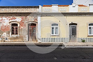 Contrast between old and dirty as well as new and painted house in Portugal