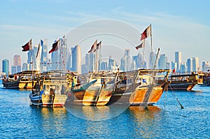 Traditional boats and modern architecture of Doha, Qatar photo