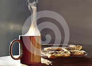 Contrasted steam from a mug containing a hot drink illuminated by the morning light and tray of small thyme mankouchi	  in Lebanon