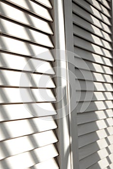 Contrasting shadows on louvered doors photo