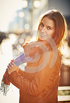 Contre-jour outdoor portrait of beautiful redhead woman