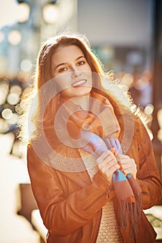 Contre-jour outdoor portrait of beautiful redhead woman