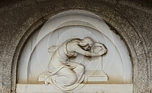 Contrite female figure on the tombstone