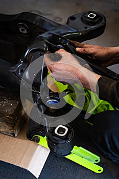 Control arms with polyurethane bushings installing process on drift car subframe. Installing drift suspension arms improves