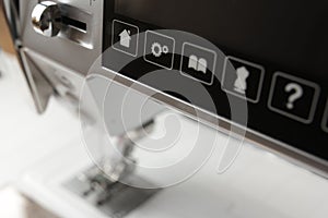 control buttons and touchscreen of a modern computerised sewing machine