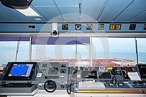 Control console on the navigational bridge of the cargo container ship.