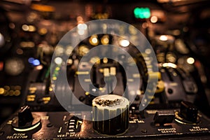 Control knobs in airplane cockpit closeup with selective focus.