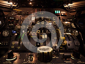Control knobs in airplane cockpit closeup with selective focus.