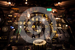 Control levers in airplane cockpit closeup with selective focus.