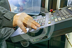 The control panel of a CNC machine, a worker writes a program for processing parts on a machine by cutting