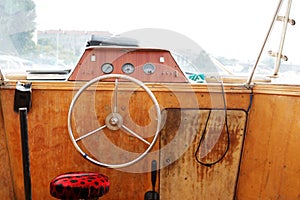 Control panel with steering wheel of the old motor boat