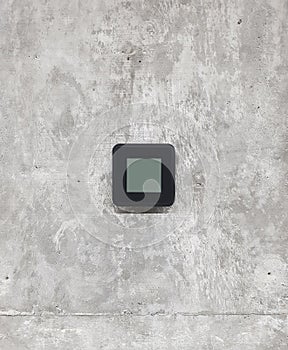 Control panel for thermostat or room climate system located on a concrete wall