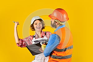 Control process. Renovation concept. Discussing renovation with contractor. Woman and man safety hard hat. Redevelopment
