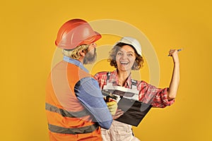 Control process. Renovation concept. Discussing renovation with contractor. Woman and man safety hard hat. Redevelopment