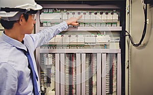 Electrician engineer tests electrical installations Power Plant Control Panel