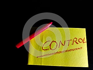 control word presented on yellow colour paper slip on dark background