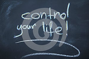 Control your life inscription on a blackboard