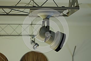 Controlled track spotlight on rail system in studio