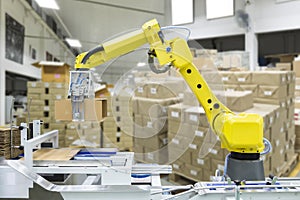 Controller of industrial robotic arm for performing, dispensing, material-handling and packaging applications in production line photo